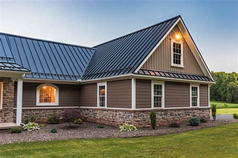 brown house and gray metal roof|dark brown roof with trim.